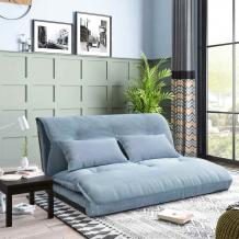 blue coloured sofa cum bed, cushions on sofa, placed in a living room, near window